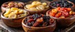 Four wooden bowls filled with a variety of fresh and colorful fruits like apples, oranges, bananas, and grapes.