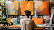 An artist working on vibrant paintings in a colorful art studio filled with canvases and art supplies.