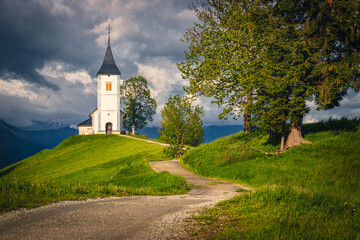 Wall Mural - Winding rural road and Saint Primoz mountain church, Jamnik, Slovenia