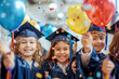 Joyful young children in graduation caps celebrate with balloons and confetti