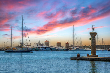 Afternoon view with the Mandraki Marina Port, symbolic deer doe statues where the Colossus of Rhodes stood. Rhodes, Greece