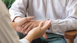 A Men patient talk with a psychologist doctor during talking therapy stressed mental health, selective focus hand, holding hand