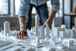 professional architect meticulously works on a blueprint with a detailed architectural model of skyscrapers on the table