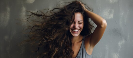 Poster - Happy woman with layered hair smiling and holding it in the air