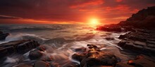 A Sunset Over A Rocky Beach With Waves Crashing Against The Rocks