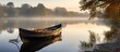A boat on a foggy lake, surrounded by mist and trees