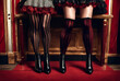 Close-up of circus performers women legs in striped red-black stockings, sitting in dressing room. Crop photo of theatrical ladies legs. Theatre stage performance concept. Copy ad text space banner