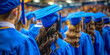 A congregation of graduates in blue caps and gowns marks a significant life milestone