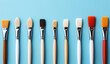 art brushes on a bright light blue background with a copy space