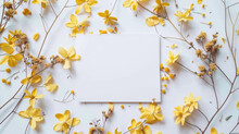 Flat Lay With Little Yellow Flowers And White Postcard With Copy Space