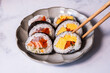 The colorful sushi roll made with egg, salmon and Kobo. Japanese cuisine and healthy eating.