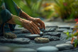 a person's hands arranging stones in a Zen garden, with soft focus and deliberate movements conveying a sense of presence and mindfulness