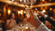 A person holding a champagne glass.
