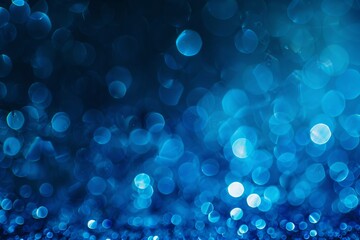 Festive blue bokeh background with sparkling glitter and shimmering lights. Perfect for Christmas and holiday-themed designs, evoking a magical atmosphere.