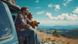 A young couple with their dog look at the view from a hill