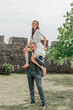 the groom holds the bride on his shoulders