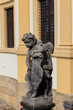 Baroque statue before facade Loreta Monastery in Prague, Czech Republic