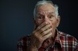 © Jorge Ferreiro - embarrassed senior man covering mouth with hands