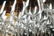 Empty glasses stands in row on rack bar for restaurant backgrounds, full frame. Close-up of wine or champagne clean glasses in row prepared by bartender for event ceremony. Copy ad text space design