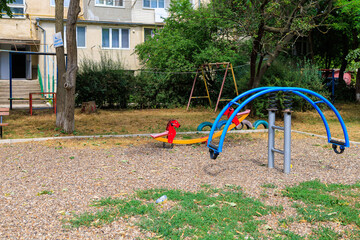 Sticker - A playground with a blue and orange swing set