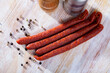 Popular thin smoked snack sausages on wooden background. Traditional Czech meat product..