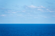 Calm Atlantic Ocean seascape, sunny day with gentle clouds on the sky. 
