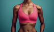 © Stock'd  - fit woman's torso in pink sports bra showing muscles isolated on plain blue color studio background