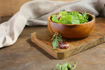 Wall Mural - baby leaves green salad on a table