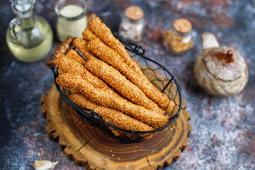 Wall Mural - Italian grissini or salted bread sticks with sesame seeds.