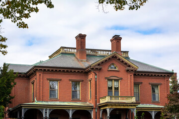 Wall Mural - Commander's Mansion, historic red brick property in Watertown Arsenal, on an autumn cloudy day, MA, USA