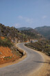 Curving road of Ha Giang loop with one cliff side and one mountain side