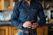 man in fitted denim shirt, jeans, sipping espresso, caf