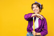 Young minded happy woman wear purple shirt casual clothes do housework tidy up hold in hand broom look aside on area mock up isolated on plain yellow background studio portrait. Housekeeping concept.