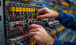Close-up photo of an electrician hands working on an tech cabinet