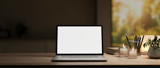 Wall Mural - A white-screen laptop computer mockup and decor on a hardwood desk in a modern dark home office.