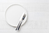 Fototapeta Desenie - Empty plate on wooden table, overhead view