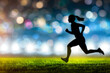 Silhouette of a female athlete running at the stadium at night
