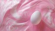 White egg on a pink marbled background