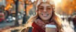 Stylish young woman smiling with a takeaway coffee cup on a sunny city street