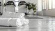 White towels rolled up and placed on a reflective floor in a gym, showcasing neatness and order