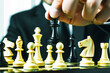 © Natalia - business strategist places chess piece on center of board target