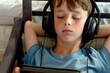 © studioworkstock - boy with headphones listening to a story on a digital tablet