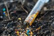 Microplastics in soil, test tube with contaminated sample close-up