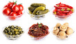 Glass bowls with pickled champignons, cucumbers, tomatoes, capers, chili pepper and sun dried tomatoes isolated on white background. Collection with clipping path.