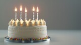 Fototapeta Las - A birthday cake with five candles blowing, isolated on a solid silver background,