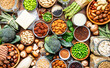 © 5ph - Vegan protein food background. Full set of plant based vegetarian food sources. Healthy eating, diet ingredients: legumes, beans, nuts, soy and almond milk, tofu, quinoa, vegetables, seeds and sprouts