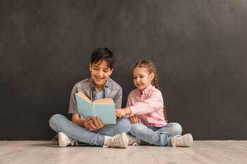 Poster - Little children reading book near blackboard