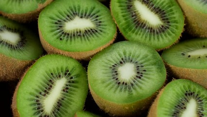 Sticker - Zoom frame kiwi fruit. Heap sliced and whole kiwi fruit close up, rotating