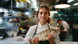 Proud woman chef with fresh fish, donning toque and apron, in high cuisine setting.