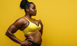 muscular poc woman plus size in gym workout clothes isolated on plain yellow color studio background and copy space